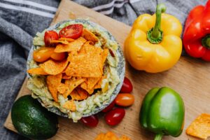 7 Amazing Tips on How to Improve Digestion Naturally at Home Healthy vegetable bowl with nachos, avocado and colorful bell peppers