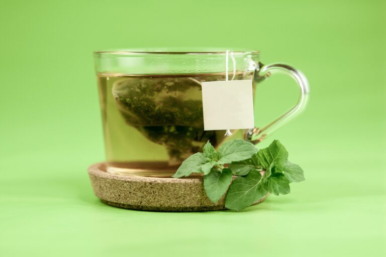 Herbal tea for sleep and relaxation in a glass cup with fresh green leaves